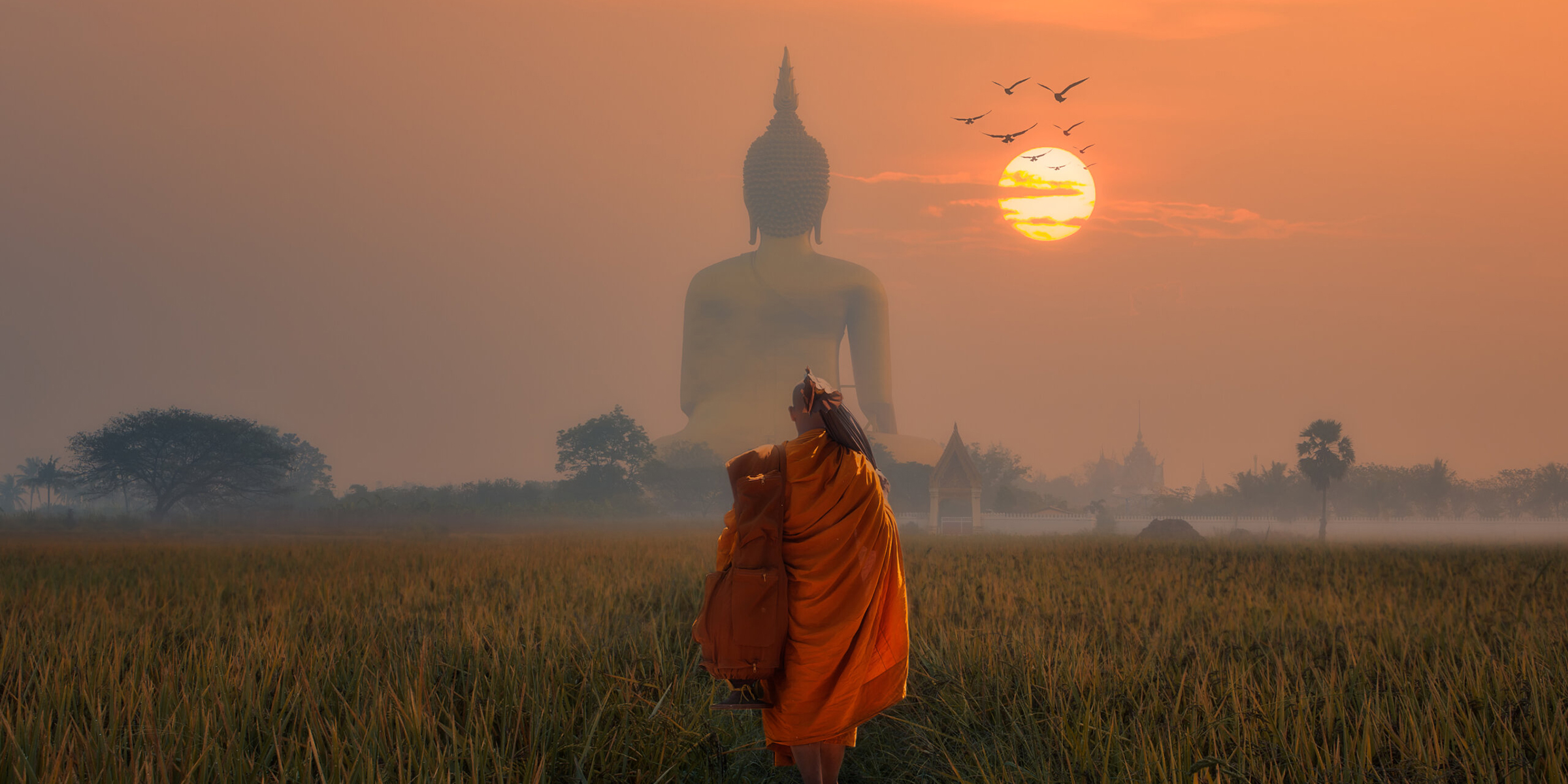Asia Monk walking dhutanga behind Big Buddha at Wat Muang Angthong, Temple thailand in sunset.